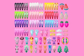A set of metal hair barrettes in bright colors and fun shapes on a pink background