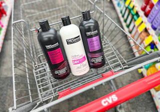 three bottles of Tresemme shampoo and conditioners