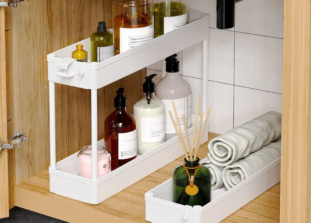 a storage cart under in a cabinet with item inside