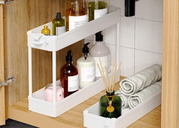 a storage cart under in a cabinet with item inside