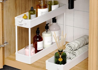 a storage cart under in a cabinet with item inside