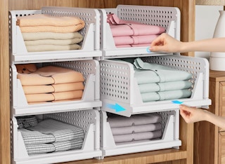 clothes folded in stackable bins on shelves