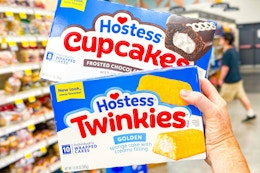 hand holding boxes of hostess snack cakes