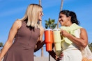 women holding stanley tumblers