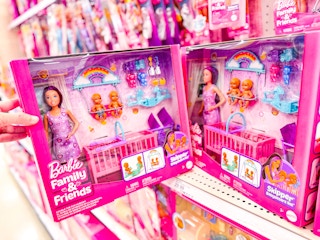 hand holding Barbie Skipper Twin Nursery Playset in front of a target shelf