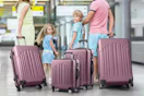 family walking with luggage