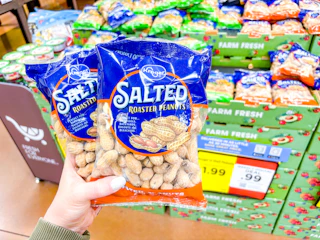 hand holding bags of kroger peanuts