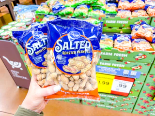 hand holding bags of kroger peanuts