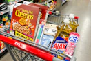 cheerios cereal, kiss nail files, ardell lashes, neutrogena wipes, ajax dish soap, and act toothpaste in a cart
