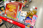 cheerios cereal, kiss nail files, ardell lashes, neutrogena wipes, ajax dish soap, and act toothpaste in a cart