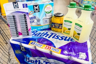 toilet paper, batteries, trash bags, pineapple spears, and lemonade in a cart