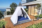 Lifestyle image of the Harper & Designs Outdoor Day Bed Tent (complete with a blue cushion)