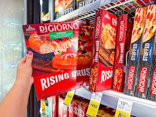 person grabbing a digiorno pizza from the freezer