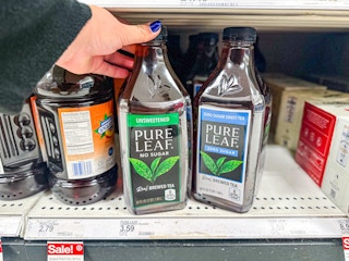 hand grabbing a pure leaf tea bottle off a target shelf