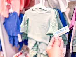 hand grabbing a carter's tag off a set at target