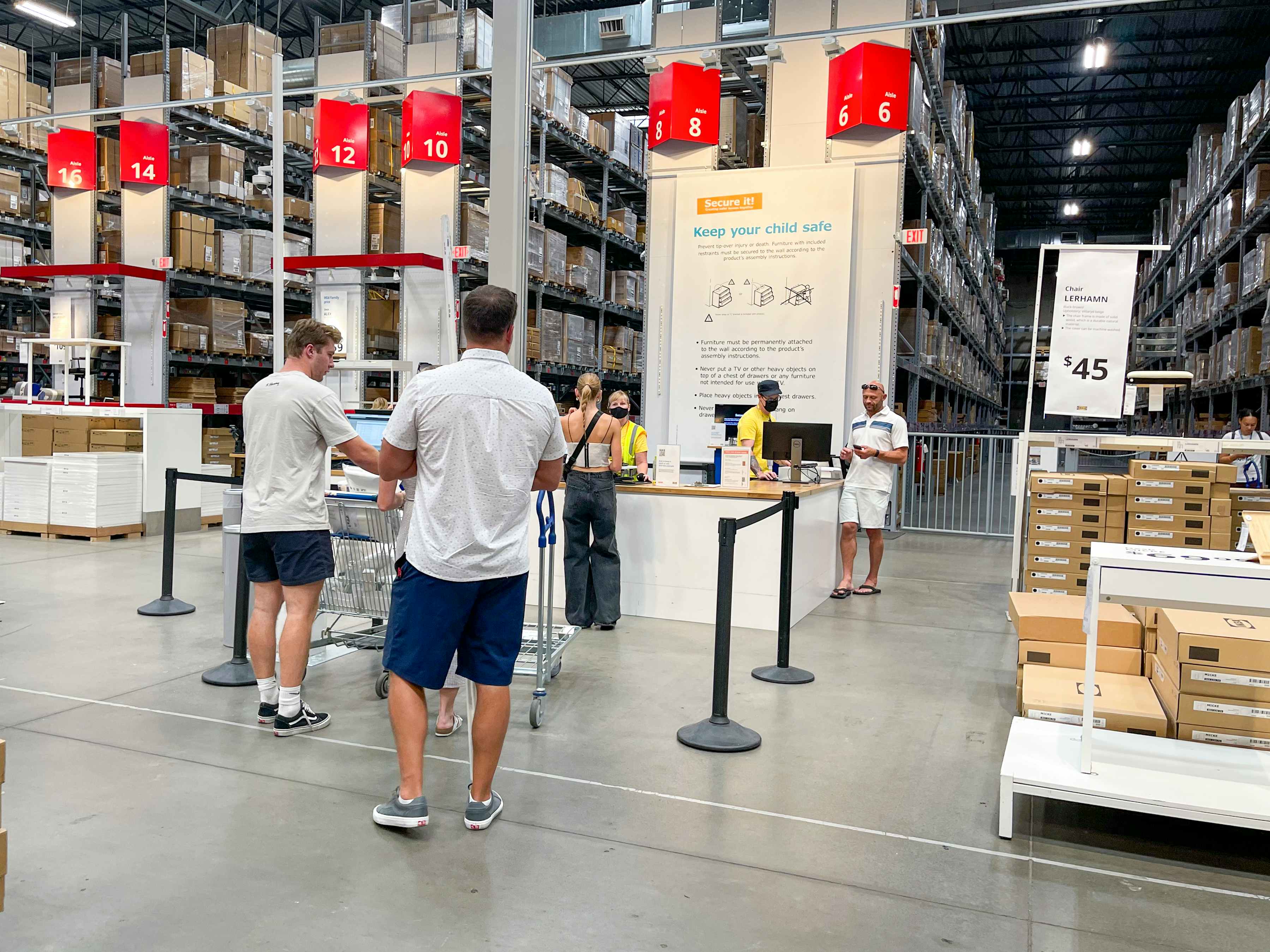 Customers waiting in like for free parts at a service desk in IKEA.
