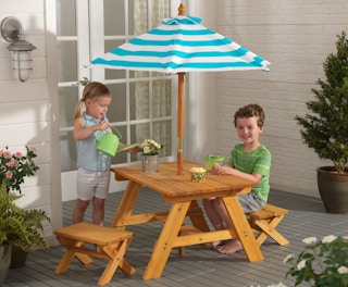 stock photo of kidkraft outdoor picnic table with kids playing