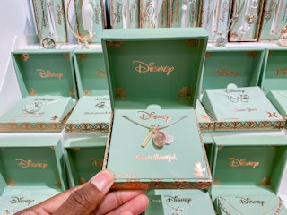 hand holding disney jewelry in box