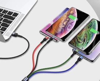 charger plugged into a laptop and four phones