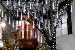 Aluan Christmas Lights Outdoor Meteor Shower Lights hanging on a tree.