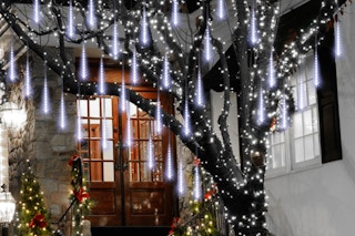 Aluan Christmas Lights Outdoor Meteor Shower Lights hanging on a tree.