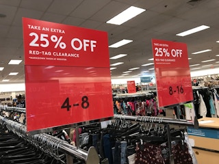 Nordstrom Rack clearance signs affixed to clothing racks