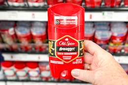 hand holding a stick of old spice deodorant