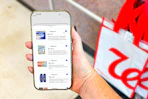 hand holding a smartphone displaying 1-clip coupons in the kcl app