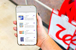 hand holding a smartphone displaying 1-clip coupons in the kcl app