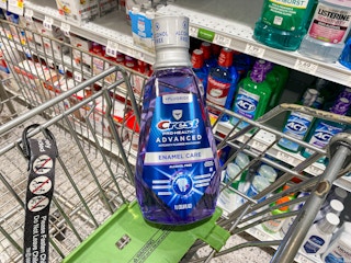A bottle of Crest mouthwash in a store cart.
