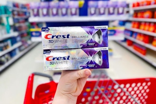 hand holding a crest 3d white premium toothpaste at target