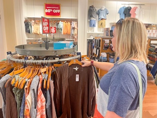 a woman looking a clearance sweaters in american eagle store