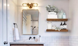 wooden shelves alongside a bathroom mirror and sink