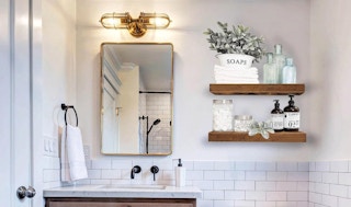 wooden shelves alongside a bathroom mirror and sink
