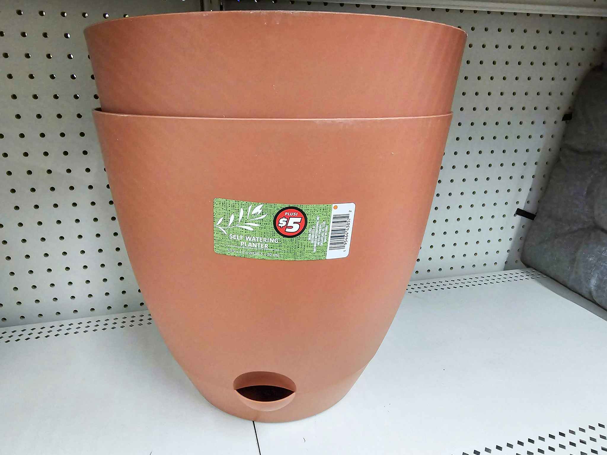 tan self watering planters on a shelf