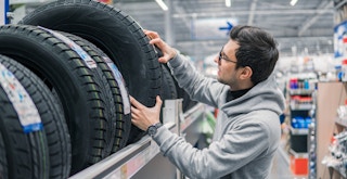 Someone shopping for tires in a store