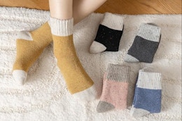 a woman sitting near wool socks