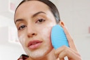 a woman using a foreo luna 3 device