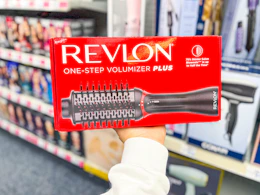 hand holding revlon one-step volumizer in cvs