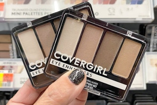 hand holding two covergirl eyeshadows