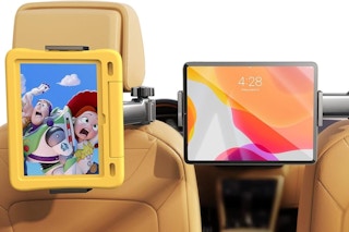 A tablet in a yellow kids' case is fastened to one headrest and pointed at the back seat passenger. A second tablet is on the passenger side
