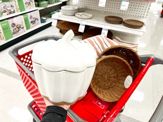 hand holding a threshold pumpkin serving bowl in front of target cart