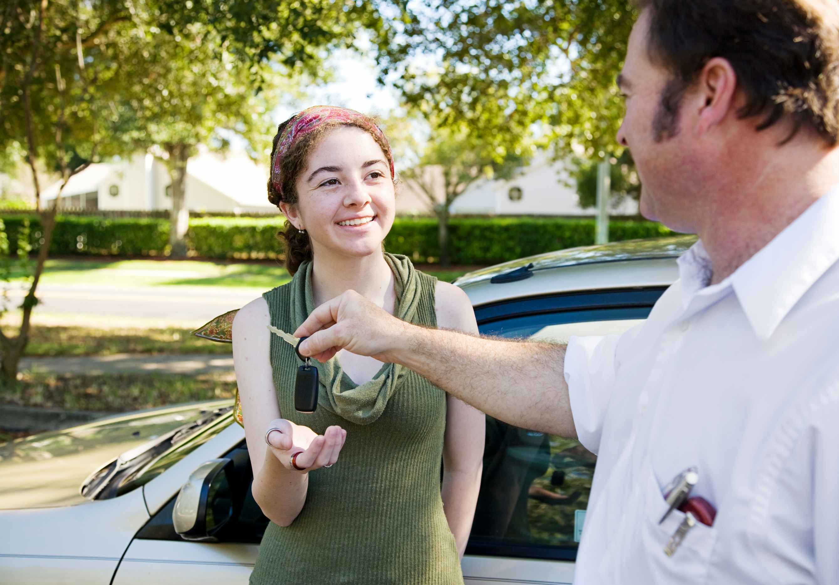 A man handing a teen car keys