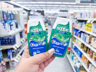 hand holding crest toothpastes in walgreens