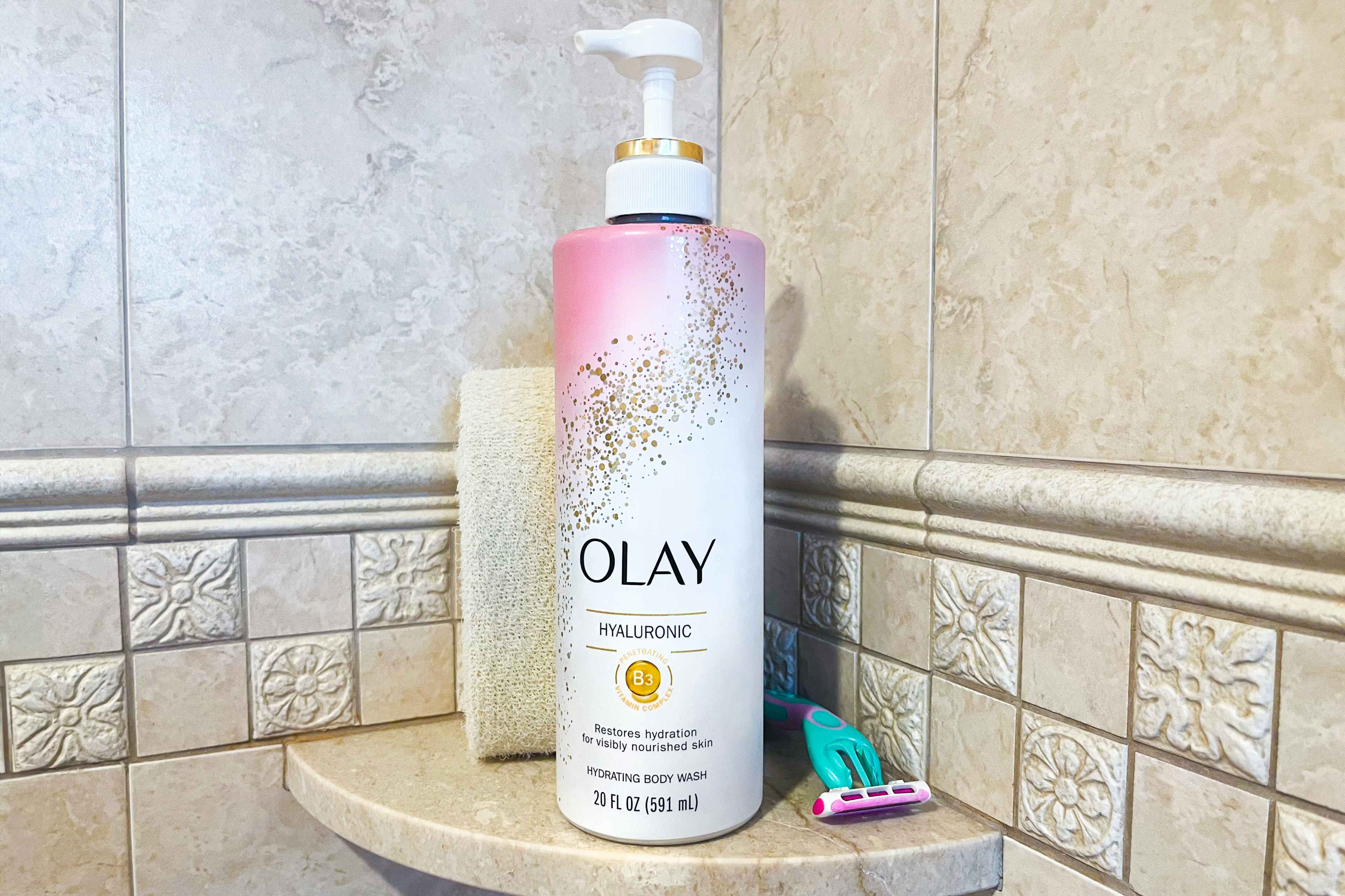 Olay body wash on a shower shelf