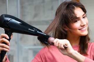 a woman using a blow dryer