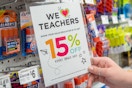 A person holding up a michaels teacher discount sign 