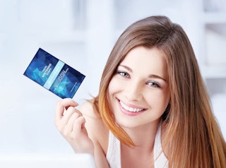 person holding teeth whitening strips