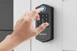 Person using the  Keyless Entry Door Lock,HEANTLE Fingerprint Smart Deadbolts with their finger.