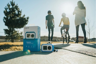 Polaroid picture in focus with kids in the distance